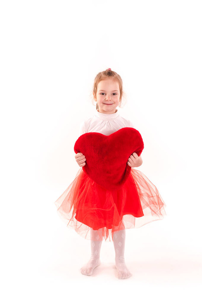 Cute little girl holding red heart isolated - Foto, Imagen