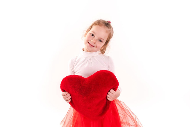 Cute little girl holding red heart isolated - Foto, Imagem