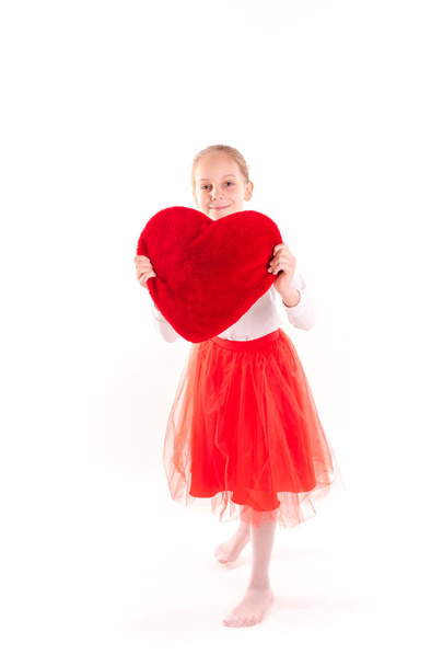 Cute little girl holding red heart isolated - Foto, immagini