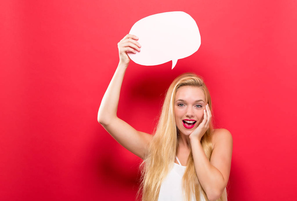 Young woman holding a speech bubble - Photo, Image