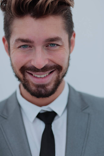 Close up portrait of a smiling handsome business man  over white - 写真・画像