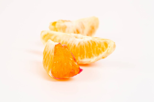 Koncepcja zdrowia świeże owoce pomarańczowy obrane segmentów na białym tle - Zdjęcie, obraz