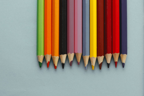 Coloured pencils isolated on the blue background - 写真・画像