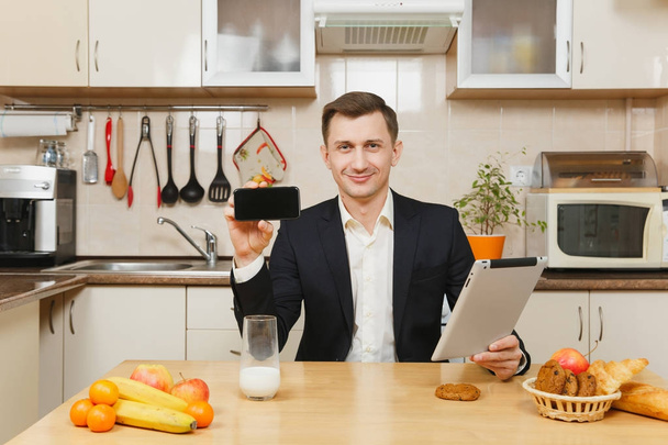 Handsome young business man in suit, shirt, having breakfast, si - Φωτογραφία, εικόνα