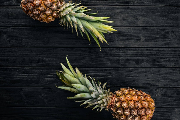 Pineapple on a wooden background. Top view. Free space for text. - Valokuva, kuva