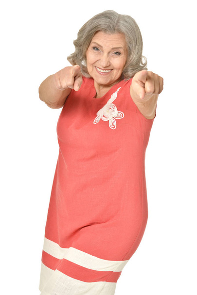 Emotional elderly woman showing something on a white background - Φωτογραφία, εικόνα