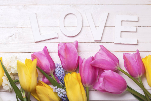 fresh spring flowers and word love - Foto, imagen