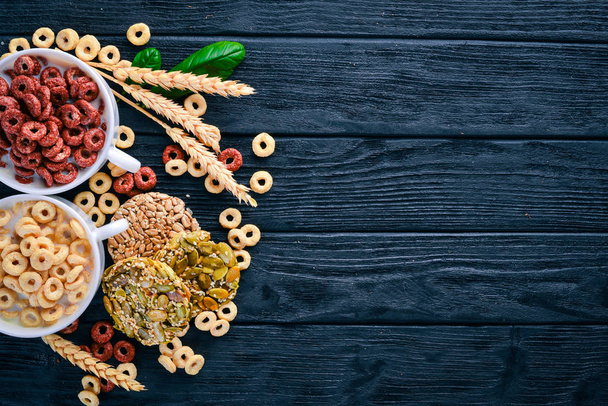 Fitness breakfast, muesli, milk, fruits, nuts and seeds, on a wooden surface. Top view. Free space for text. - Photo, Image