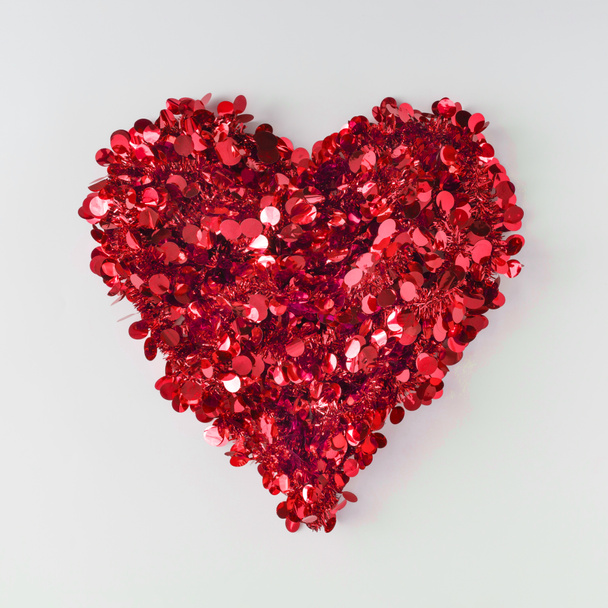 heart shape made of bright red glitter on light background, love concept  - Photo, Image