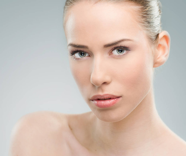 Beautiful woman close up over a light gray background - Photo, Image