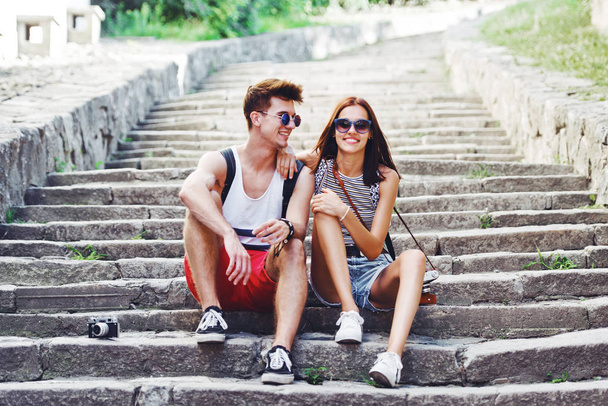 Two young tourists taking a break on old stairway - Foto, immagini