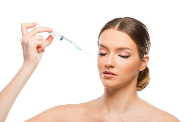 Beautiful young woman doing botox injection - 写真・画像