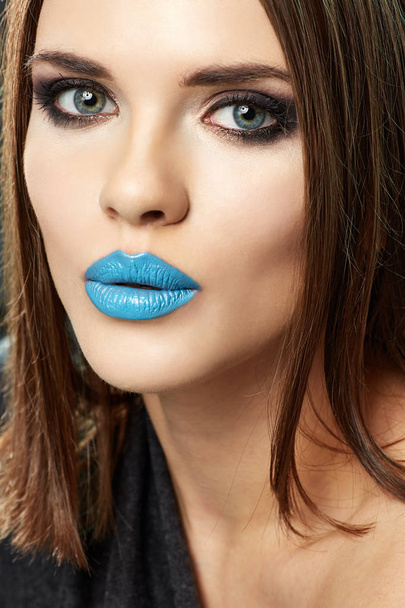 portrait of beautiful brunette woman with teenager style makeup and blue lips  - Фото, изображение