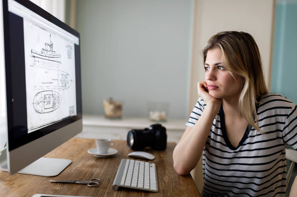 Portrait of young woman designing  - Photo, image