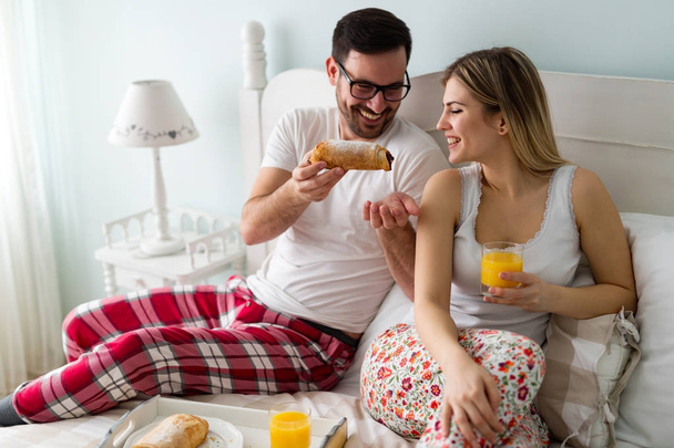 couple having breakfast in bed - 写真・画像