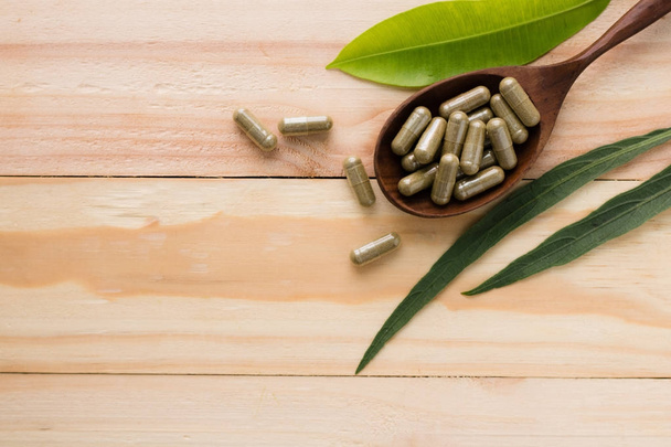 herbal drug or pill on wood background - Φωτογραφία, εικόνα