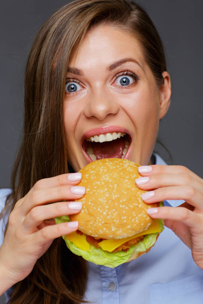 close-up portrait of woman face biting hamburger  - Foto, immagini