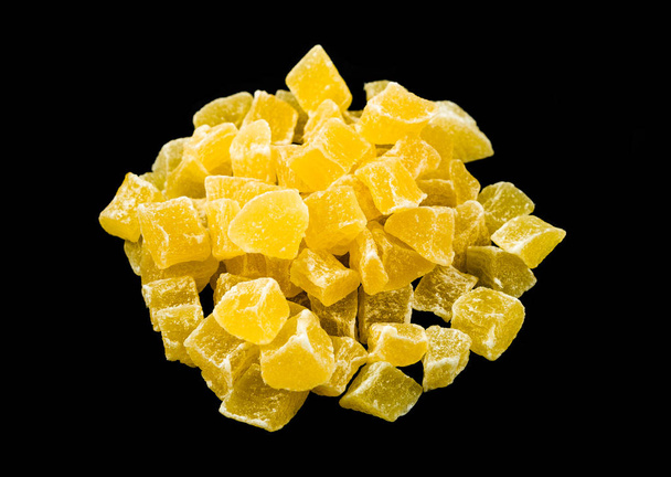 Candied dried pineapple isolated on black background - Foto, Imagem