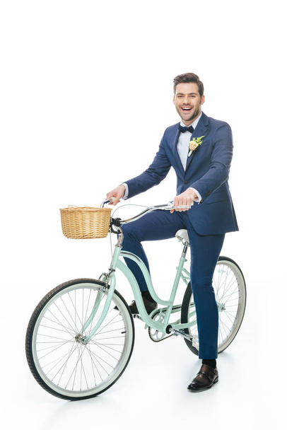 cheerful groom riding retro bicycle isolated on white - Φωτογραφία, εικόνα