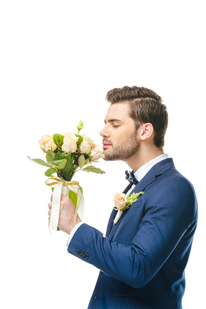 side view of groom with wedding bouquet in hand isolated on white - Fotoğraf, Görsel