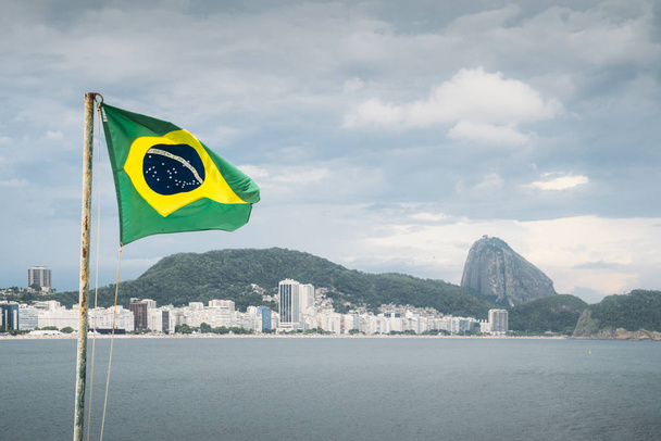 Brazilian flag waving in Copacabana, Brazil - Photo, Image