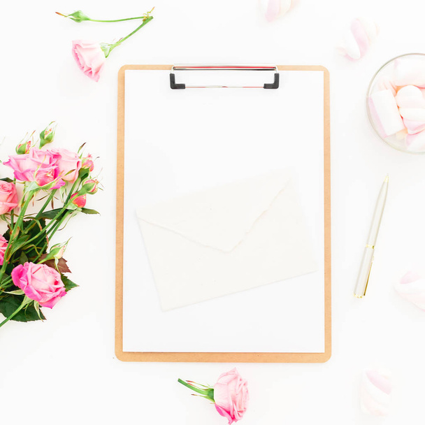 Beauty composition with marshmallow, pink roses bouquet and clipboard on white background. Top view. Flat lay. - Photo, Image