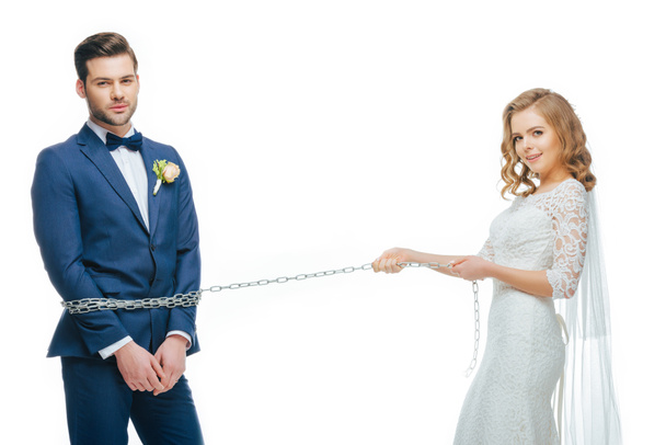 young bride holding groom on chain isolated on white - Φωτογραφία, εικόνα