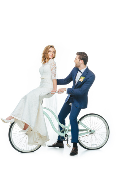 wedding couple riding retro bicycle isolated on white - Photo, Image