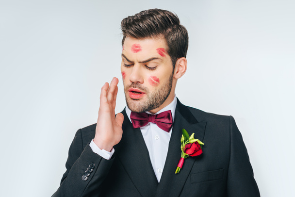 portrait of handsome groom in suit with red lipstick on face - Fotografie, Obrázek