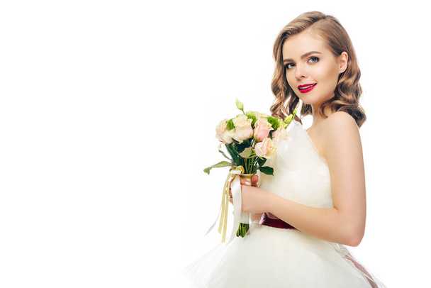 side view of bride in wedding dress with bouquet of flowers in hands isolated on white - Φωτογραφία, εικόνα