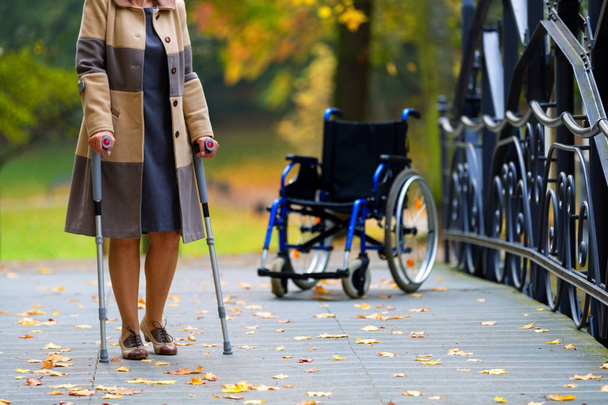 older woman practicing walking on crutches - Fotoğraf, Görsel