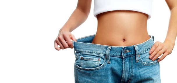 Woman is measuring waist after weight loss,. Diet concept - Zdjęcie, obraz