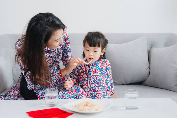 Vietnamese mother and daughter celebrate new year at home. Tet Holiday. - Photo, Image