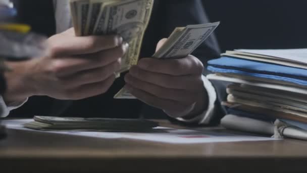 Close up hands of businessman at workplace counting money. Man counting Many American 100 bills. Concept of salary or making money. - Footage, Video