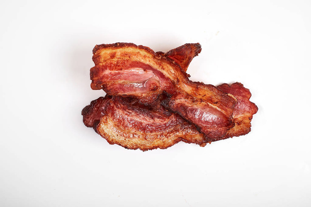 crispy fried bacon isolated on a white background. - Photo, Image