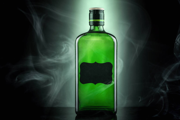 Alcohol in a green bottle  - Фото, зображення