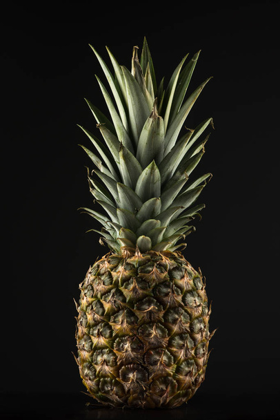 Pineapple on a black background - Foto, afbeelding