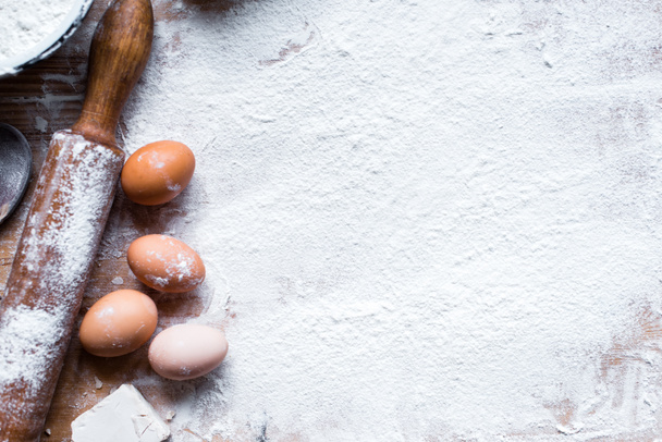 Ingredients for cooking baking - flour, dough on wooden background  - Photo, image