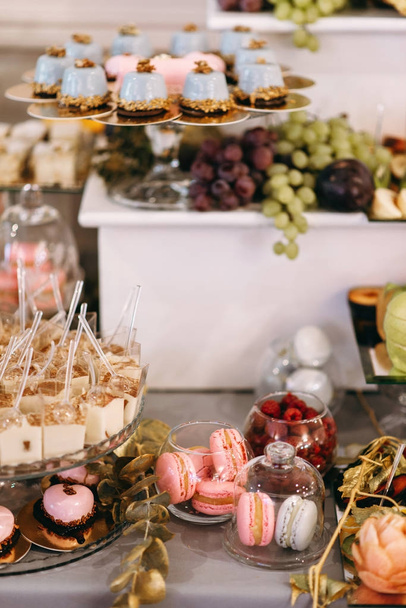 Wedding sweet table with desserts and cakes. A beautiful wedding reception - 写真・画像