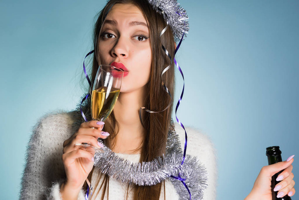 young drunk girl celebrates the new year, drinks champagne - 写真・画像