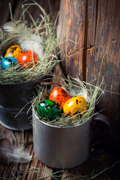 Easter eggs with hay in old metal mug - Φωτογραφία, εικόνα