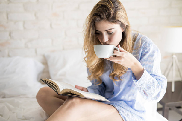 Drinking coffee and reading - 写真・画像
