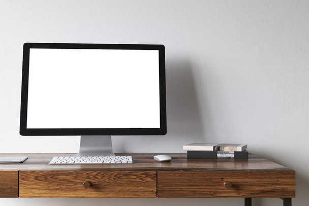 White computer screen on a dark wooden desk - Foto, Bild