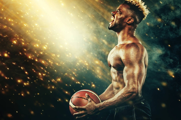 Basketball Wallpaper. Portrait of afro-american sportsman, basketball player with a ball over black background. Fit young man in sportswear holding ball. - Foto, afbeelding