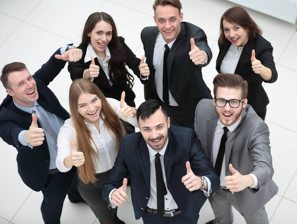 successful business team holding up a thumbs up - Fotografie, Obrázek