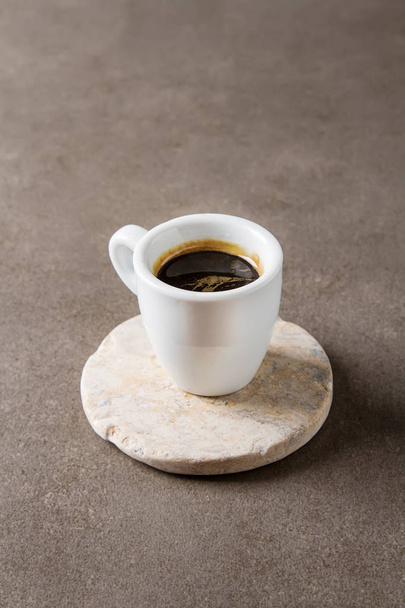 Italian homemade espresso coffee in a white mug. Dark background - Фото, зображення