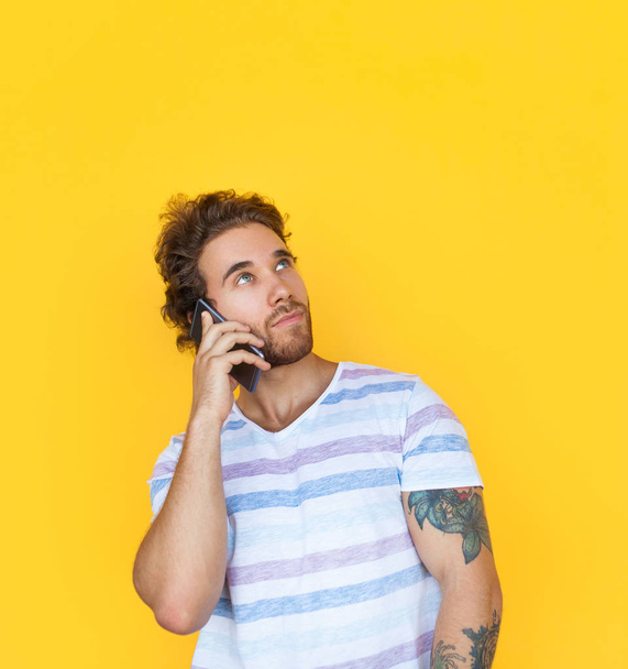 Content man talking on phone in studio - Фото, изображение