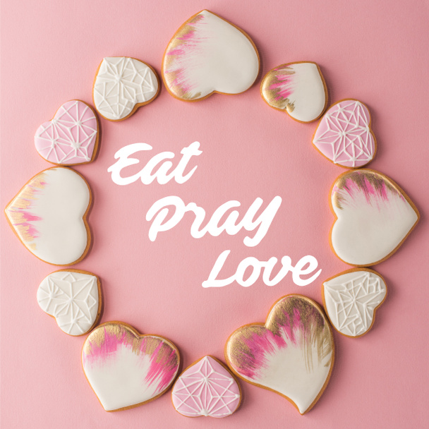 flat lay with arrangement of glazed heart shaped cookies isolated on pink surface - Photo, Image