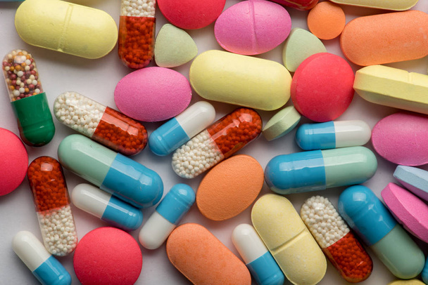 Pharmacy theme. Multicolored Isolated Pills and Capsules - 写真・画像