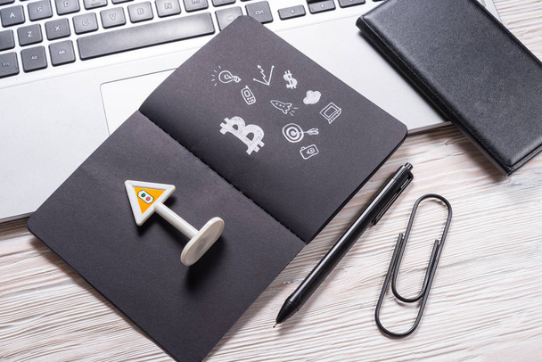 Black paper notebook on office desk, cryptocurrency concept - Φωτογραφία, εικόνα